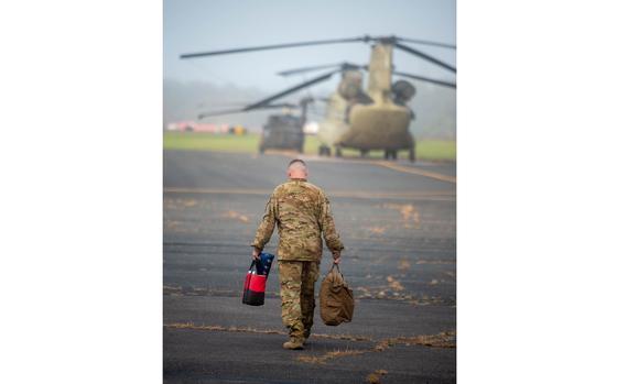 A member of the UH-60 Blackhawk helicopter flight crew makes his way to his helicopter as members of the Connecticut National Guard’s Bravo Company, 2-104th Aviation, 1-169th Aviation Regiment prepare to depart from the Army Aviation Support Facility in Windsor Locks for a one week deployment to Salisbury, North Carolina on Friday, Oct. 4, 2024. This is the Connecticut National Guard’s second group they are sending to assist with Hurricane Helene disaster response.  (Aaron Flaum/Hartford Courant)