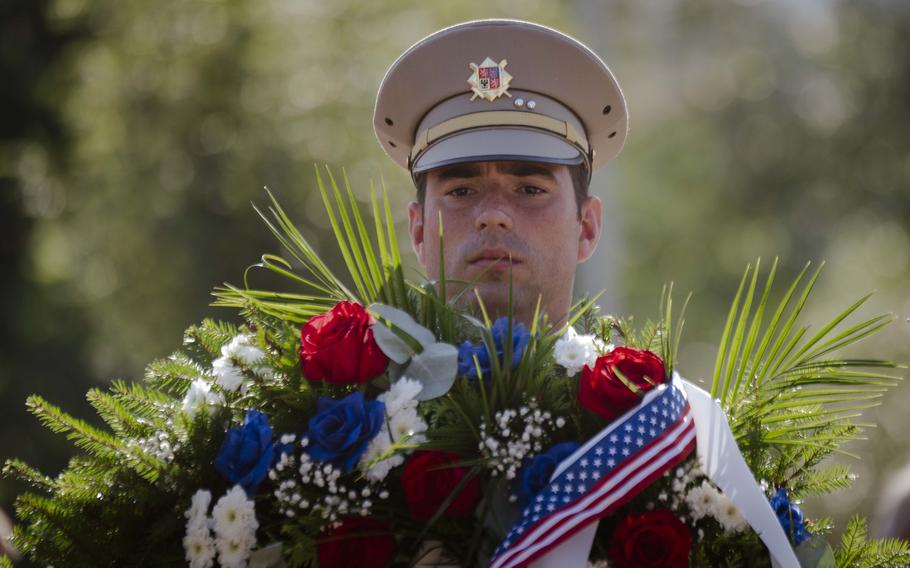 A Czech soldier lays a wreath at the mass grave site of 28 fallen American Word War II service members during the 80th commemoration of the Battle over the White Carpathians at Slavicin, Czech Republic, on Aug. 31, 2024.