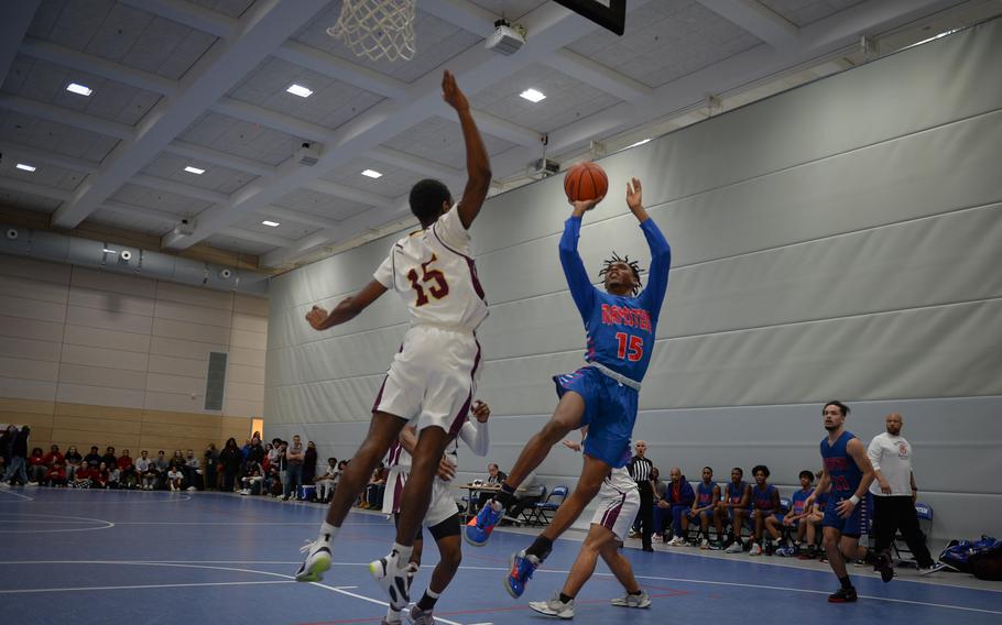Jayvian Jennings of the Ramstein Royals tries to get a shot past Vilseck's Ibrahima Balde during the DODEA European Division I boys basketball championships Feb. 16, 2023, at Ramstein Air Base, Germany. Ramstein ended the game 48-22 over Vilseck. 