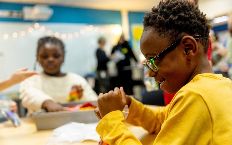 First and second grade students help fill bags of donated Halloween candy 