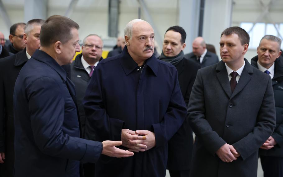 A group of men seen from the waist up; in the center is the president of Belarus.