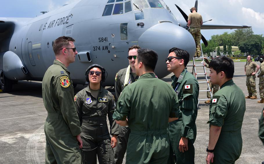 Airmen from the U.S Air Force’s Yokota Air Base, Japan, and the Japan Air Self-Defense Force discuss upcoming operations for Pacific Airlift Rally 2023 at Clark Air Base, Philippines, Aug. 14, 2023.