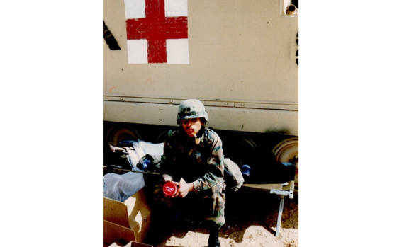 M.R. Gonzales is seen in his fatigues, sitting in front of a medical vehicle.