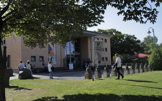 Visitors stand outside the entrance of the Lava Dome Volcano Museum, waiting for the start of their tour Sept. 21, 2024, in Mendig, Germany. The museum serves as an introduction to the geological wonders of the area, offering insight into the volcanic forces that shaped the region.