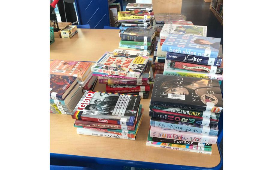 A pile of books on a table.