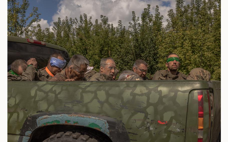 A Ukrainian military vehicle drives from the direction of the border with Russia carrying blindfolded men in Russian military uniforms, in the Sumy region, on Aug. 13, 2024, amid the Russian invasion of Ukraine. 