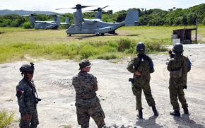 Troops from the Philippines, U.S. and Japan watch a Marine Corps MV-22B Osprey land during disaster-response training near Camp Cape Bojeador, Philippines, Oct. 20, 2024.
