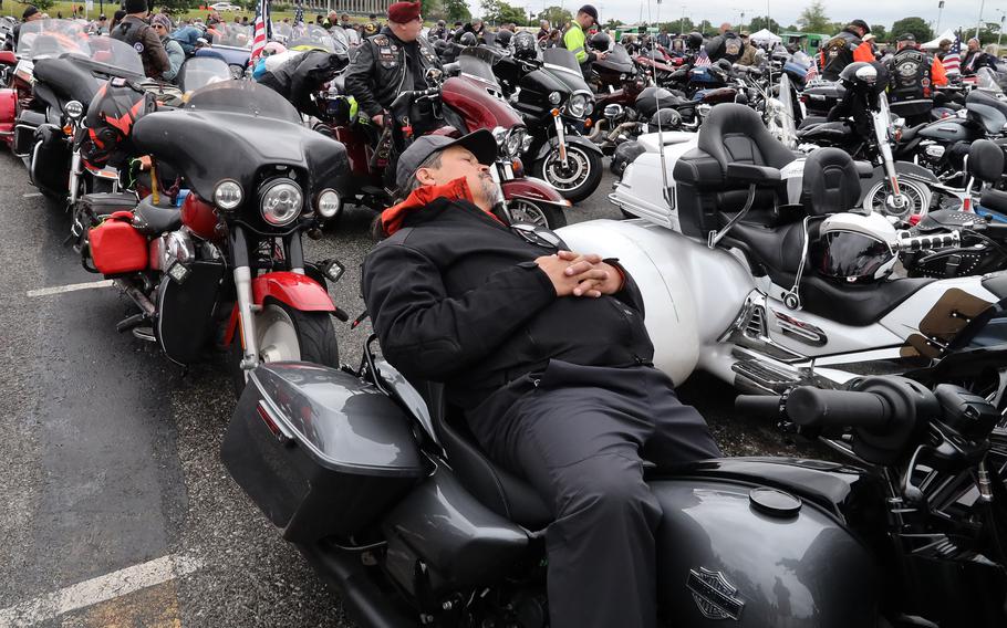 A rider takes a nap in the RFK Stadium staging area while awaiting the start of the Rolling to Remember ride, May 30, 2021 in Washington, D.C..