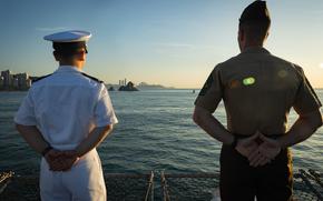 A U.S. Navy sailor attached to the amphibious assault ship the USS America (LHA 6), left, and a U.S. Marine attached to the 31st Marine Expeditionary Unit, man the rails during a scheduled port call to Busan, South Korea, during exercise Ssang Yong 24, Sept. 5, 2024. Exercise SY24 strengthens the Republic of Korea-U.S. Alliance through bilateral, joint training, contributing toward combined amphibious capability in defense of the Korean Peninsula. The 31st MEU is operating aboard ships of the USS America Amphibious Ready Group in the 7th Fleet area of operations, the U.S. Navy’s largest forward-deployed numbered fleet, and routinely interacts and operates with allies and partners in preserving a free and open Indo-Pacific region. (U.S. Marine Corps photo by Cpl. Juan Maldonado)