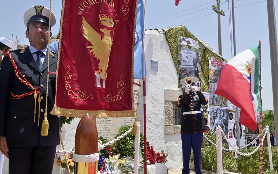 Gunnery Sgt. Joseph Melendez plays taps at an Operation Husky 80th anniversary ceremony, at the 82nd Airborne Division Monument at Ponte Dirillo in Gela, Italy, July 10, 2023. 