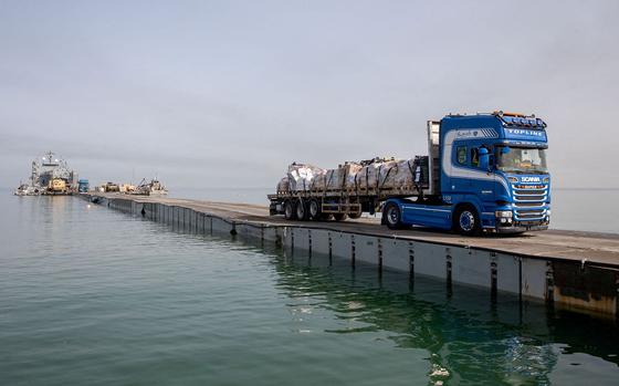 A truck carries humanitarian aid across the Trident Pier off the Gaza coast on May 19, 2024.