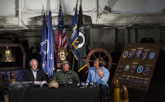 From left: Ted Alexander, host of the Ricky Rahne Coach's Show with Capt. Christopher Hill, CO of the aircraft carrier Eisenhower and Ricky Rahne, head football coach at Old Dominion University during a broadcast of the show on WVSP-FM from the hangar deck of the Eisenhower at Naval Station Norfolk Monday evening, Oct. 21,2024. (Bill Tiernan/ For The Virginian-Pilot)