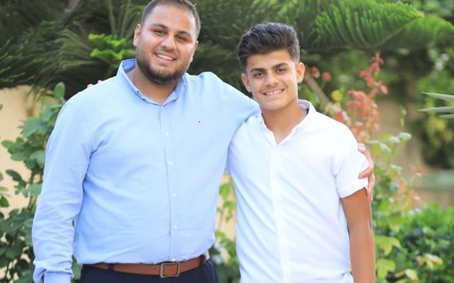 Hamza Dahdouh, left, with his brother, Mahmoud, who was also killed in an Israeli strike.