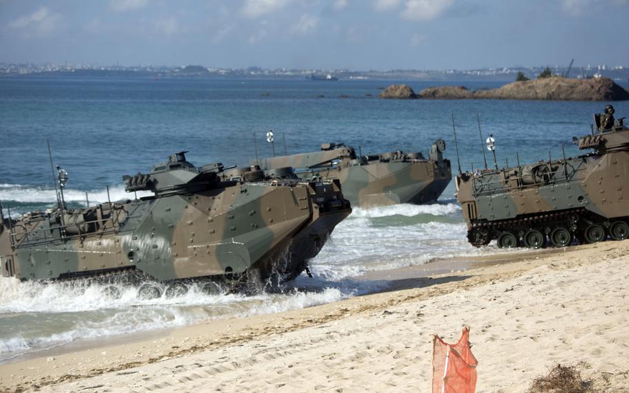 Japanese amphibious assault vehicles roll onto Kin Blue Beach.