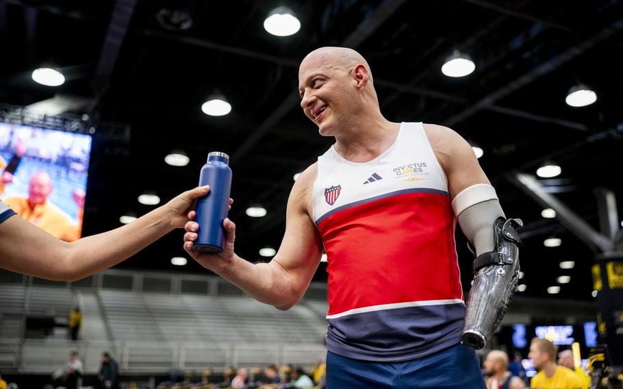 A competitor grabs a bottle of water