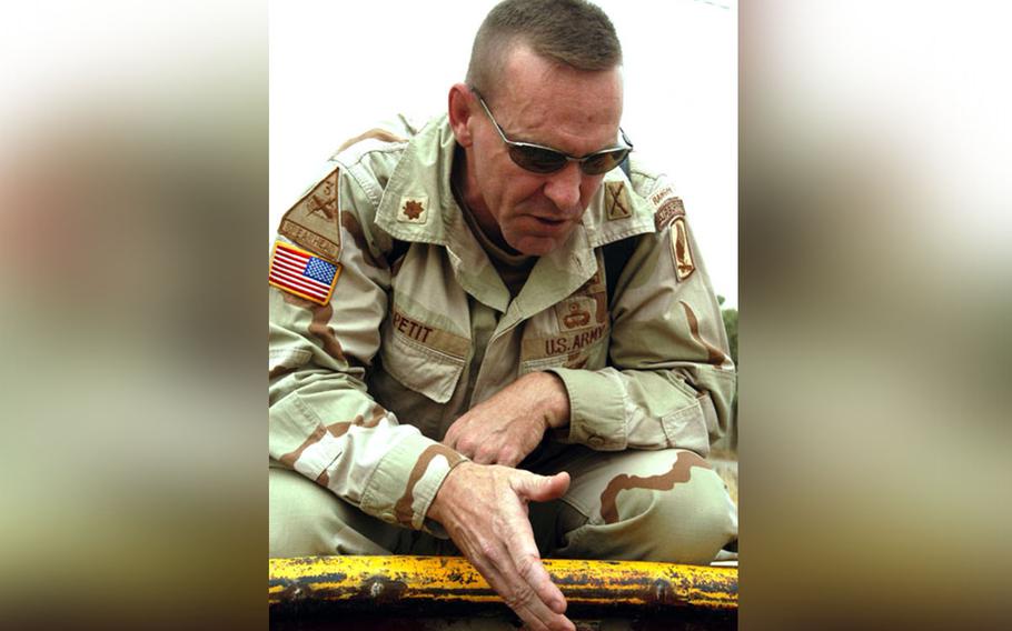 Maj. Kevin Petit, executive officer of the 173rd Airborne Brigade, explains how soldiers of the brigade stopped a truck loaded with 999 bars of gold, at a checkpoint on the outskirts of Kirkuk, Iraq, on Sunday.