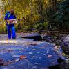 Corey Anderson, an intermediate care technician with the Asheville, N.C., Veterans Affairs Department medical center, carries medical supplies on a mountain road near Asheville, N.C., which was devastated by flooding and landslides from Hurricane Helen, which hit Sept. 27. (Photo by Kathie Ramos/Asheville VA)