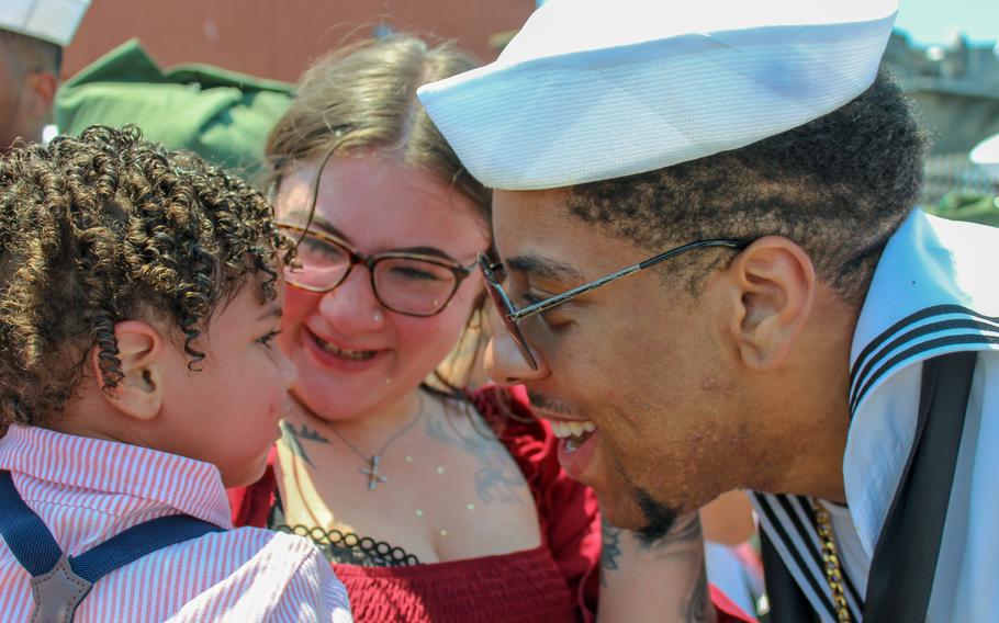 Boatswain's Mate Kei-Ard Bell greets his wife, Callie Bell, and their 1-year-old son, Malachi, at Naval Station Norfolk, Virginia, Sunday, July 14, 2024. The USS Dwight D. Eisenhower and approximately 5,000 Sailors returned home from a deployment in the Red Sea. 