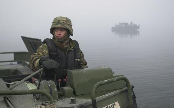 Imjin river valley, South Korea, Mar. 2, 2002: Army Pvt. Jason Rivas, a bridge crewmember on a bridge-erection boat, keeps in position the bays, which form the bridge, at the Army Training Evaluation Program in South Korea. What appears to be fog is actually smoke, created with smoke track vehicles of the 4th Chemical Company, to block the bridge building activity from enemy view and protect it against aircraft and artillery.

Read the full story on the training and see additional photos here.

META TAGS: 4th Chemical Company; 50th Engineer Company; 2nd Infantry Division; U.S. Army; Army Training Evaluation Program; logistics; 