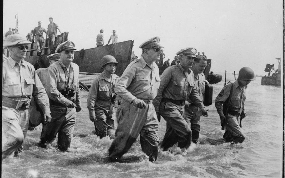 Army General Douglas MacArthur wades ashore during the first landings in Leyte, Philippines, in October 1944.