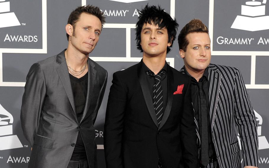 Members of Green Day, from left, Mike Dirnt, Billie Joe Armstrong and Tre Cool, appear at the Grammy Awards in Los Angeles on Jan. 31, 2010. 