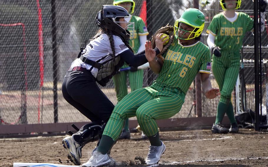 Zama's Evangeline Nelson tags out Edgren's Sydney Johnson during Saturday's DODEA-Japan softball twin bill. The Trojans won the opener 16-15 and the Eagles the nightcap 25-7.