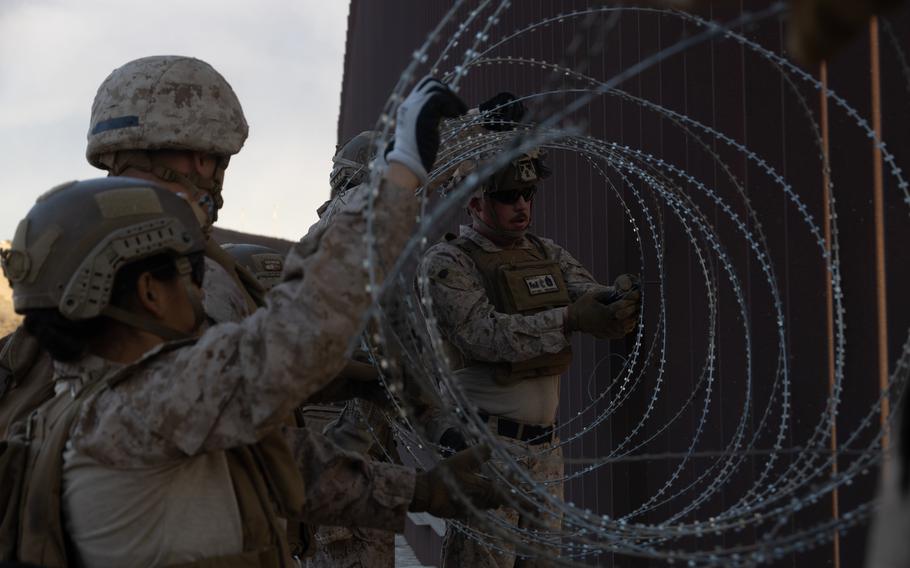 Marines set up concertina wire