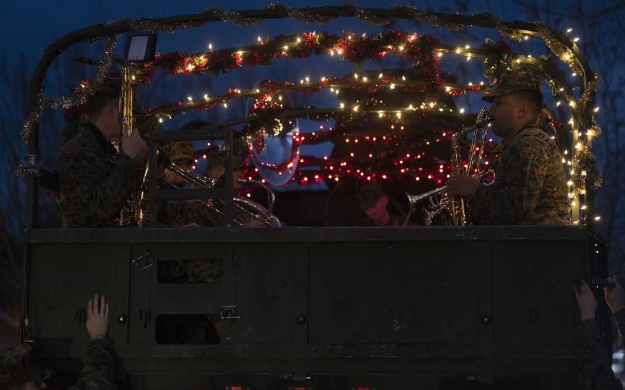 U.S. Marines with the 2nd Marine Division Band perform during the 2d MARDIV Seven Ton Caroling on Marine Corps Base Camp Lejeune, N.C., Dec. 17, 2024. The 2d MARDIV Band performed throughout Tarawa Terrace Neighborhood Base Housing for Marines and families to celebrate the holiday season. 