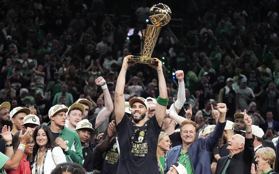 Jayson Tatum raises the Larry O'Brien Championship Trophy after the Celtics defeated the Mavericks to win the NBA title on June 17, 2024.