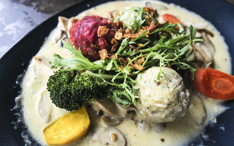 A plate of mixed dumplings served with fresh king oyster mushrooms in a light, creamy sauce is a vegetarian's delight at Zum Landgrafen restaurant in Ludwigswinkel, Germany. The restaurant's menu lists several vegetarian options.