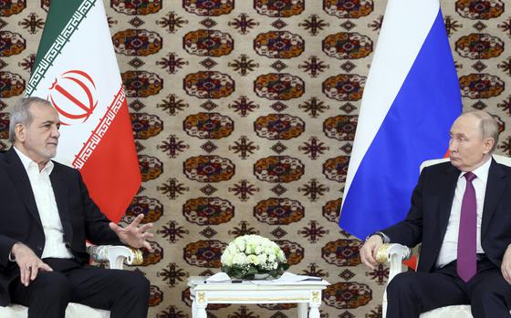 Russian President Vladimir Putin, right, listens to Iranian President Masoud Pezeshkian during their meeting on the sidelines of the International Forum "The Interconnection of Times and Civilizations – the basis of peace and development" dedicated to the 300th anniversary of the birth of the outstanding Turkmen poet and thinker Magtymguly Fragi in Ashgabat, Turkmenistan, Friday, Oct. 11, 2024. (Alexander Shcherbak, Sputnik, Kremlin Pool Photo via AP)