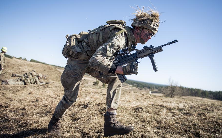 A Royal Military Academy Sandhurst cadet from the runs to the firing line during a platoon attack at Grafenwoehr Training Area.