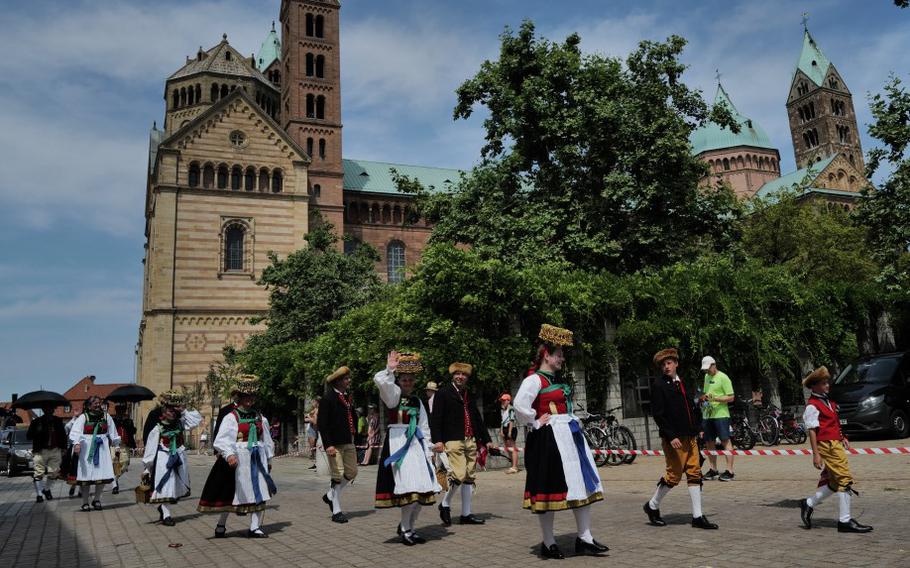 
Participants in traditional costumes march through the streets of Speyer during last year’s Pretzel Festival parade on July 9, 2023. Parade attendees stand to gather plentiful pretzel and candy during the city-wide celebration.