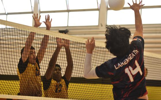 Bahrain's Zeyad Rmadan, left, and Enoch Oduro wait for Lakenheath's Rylen Pontemayor to hit the ball over the net on the opening day of the DODEA-Europe Boys Volleyball Championships on Thursday, Oct. 31, 2024, in Vicenza, Italy.