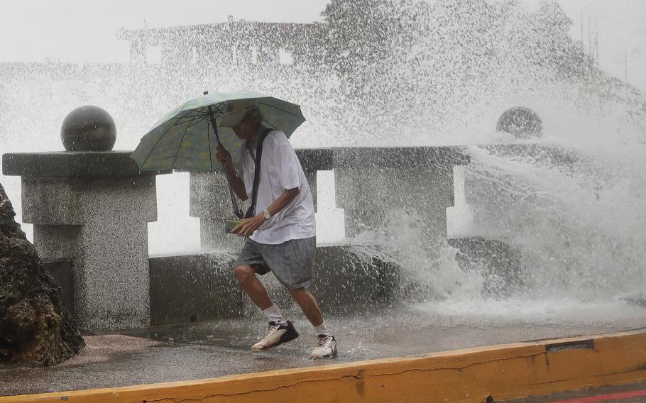 A man runs away from waves