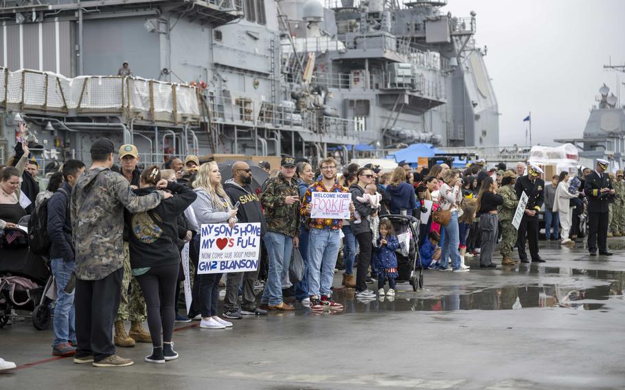 Friends and family wait for the USS O’Kane to pull into its homeport