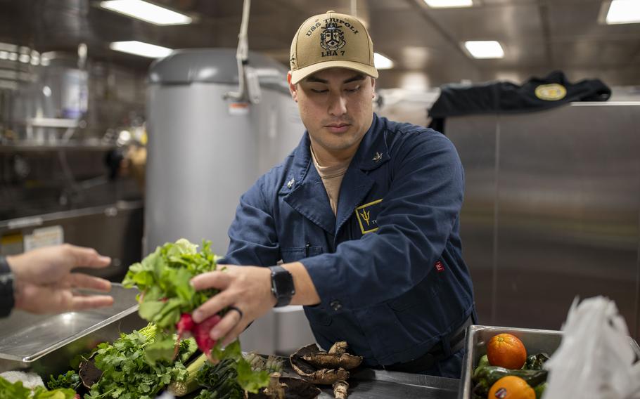 Culinary Specialist 2nd Class Tyler Perez, from El Paso, Texas, prepares vegetables