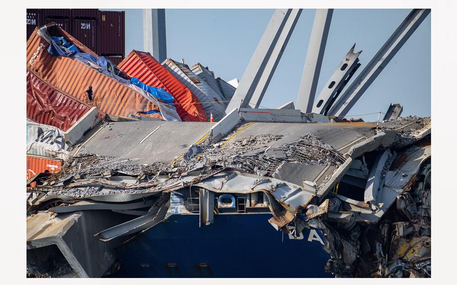 A section of I-695 is still draped across the bow of the Dali following a planned explosion Monday, May 13, 2024, that cut apart a section of steel truss from the Francis Scott Key bridge. 