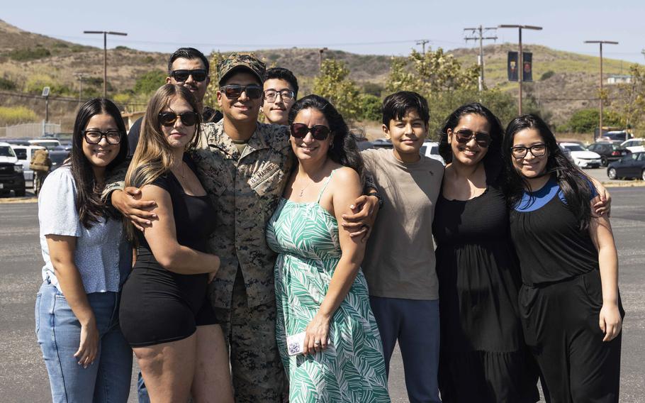 U.S. Marine Corps Lance Cpl. JC Sosa, a rifleman with Charlie Company, Battalion Landing Team 1/5, 15th Marine Expeditionary Unit, and a native of Merced, Calif., poses for a group photo with his family at Marine Corps Base Camp Pendleton, Calif., on Aug. 10, 2024, after returning from deployment.