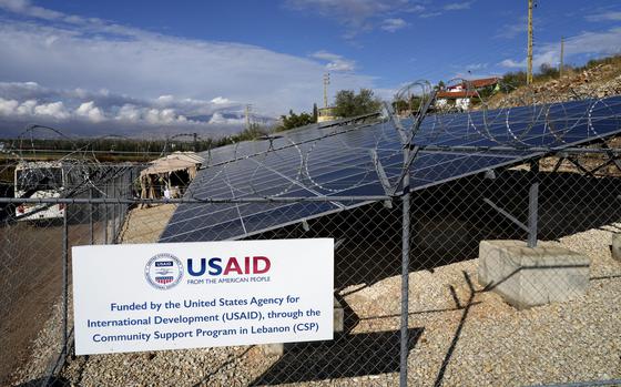 A sign denotes solar panel systems funded by the United States Agency for International Development (USAID).