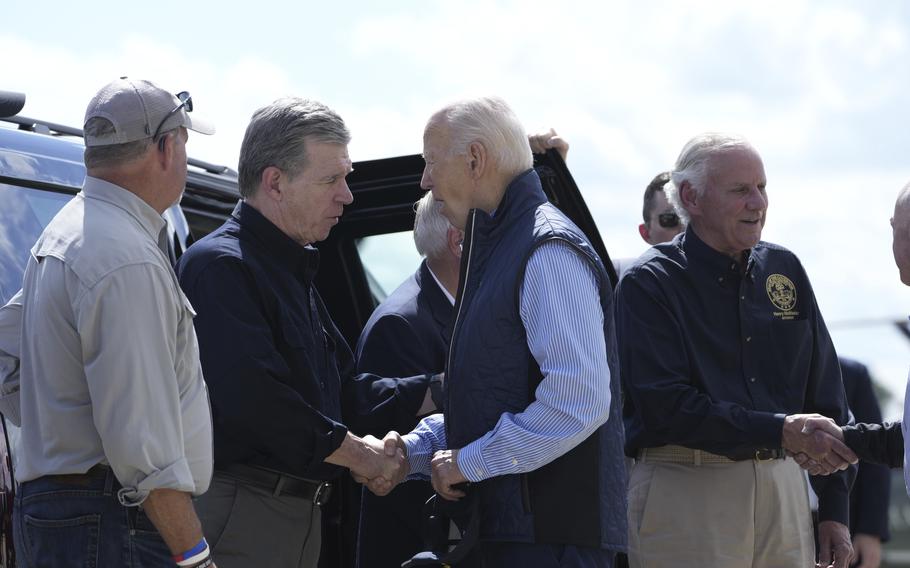 President Joe Biden shakes hands with North Carolina Gov. Roy Cooper at Greenville-Spartanburg International Airport. 