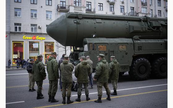 FILE - Soldiers stand next to a Russian RS-24 Yars ballistic missile parked along Tverskaya street prior to a rehearsal for the Victory Day military parade in Moscow, on May 2, 2024. Russia's nuclear doctrine says the country could use nuclear weapons in response to a nuclear strike or an attack with conventional weapons that threatens "the very existence" of the Russian state. (AP Photo/Alexander Zemlianichenko, File)