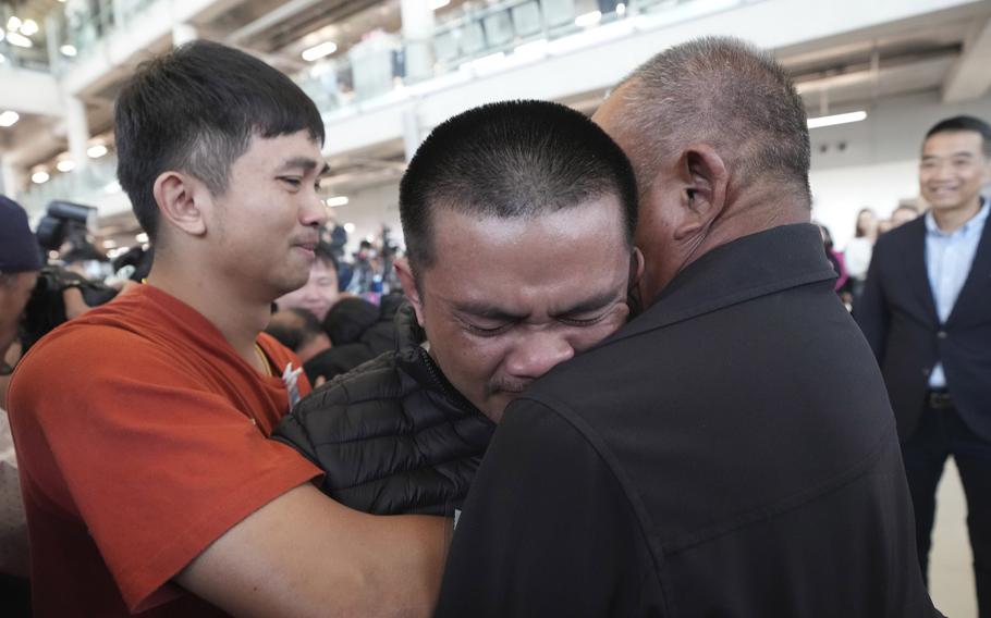 A Thai hostage who was freed from Hamas hugs a relative.