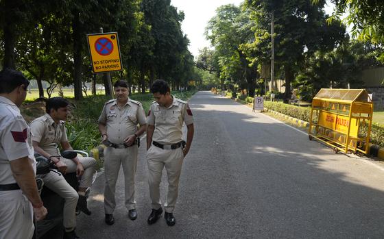 Indian policemen guard a road leading to the Canadian high commission in New Delhi, Oct. 15, 2024.