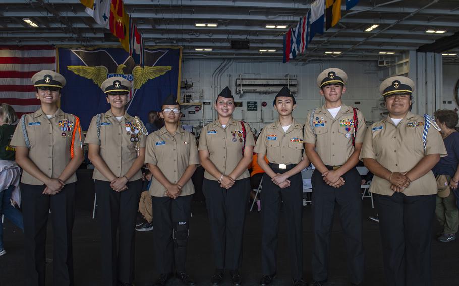 La Habra High School Navy Junior Reserve Officer Training Corps cadets pose for a group photo in the hangar bay aboard USS Carl Vinson while underway for a Family and Friends Day Cruise on Saturday, Aug. 17, 2024.