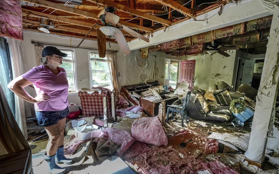 Cindy White looks over the devastation inside her home caused by Hurricane Helene, Tuesday, Oct. 1, 2024 in Morganton, N.C. The adjacent Catawba River flooded due to the torrential rains destroying the seven of family's nine homes on the property.