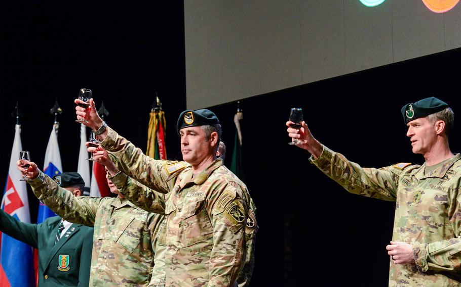 Four officers raise glasses and give a toast.