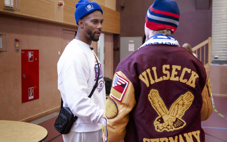 Victor Cruz, a former wide receiver for the New York Giants, talks to a student at Vilseck High School in Germany on Nov. 7, 2024. Cruz and fellow former Giants player Brandon London visited Vilseck schools to talk to students.