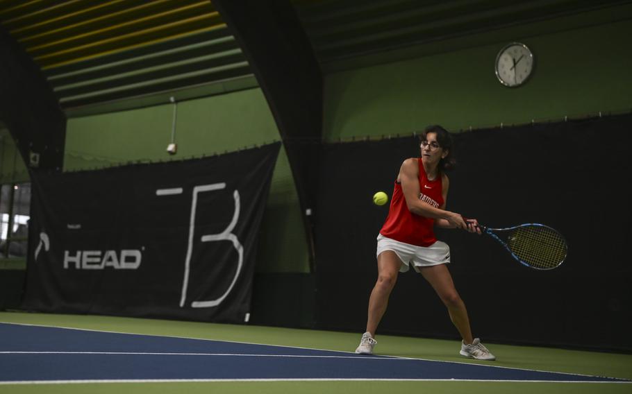 Kaiserslautern's Alisa Dietzel positions herself at the baseline, poised to unleash a powerful backhand against Vicenza opponents, Ava Parker and Sarah McGovern, keenly anticipate her next move during the DODEA European tennis championships at T2 Sports Health Club in Wiesbaden, Germany, on Oct. 21, 2023.