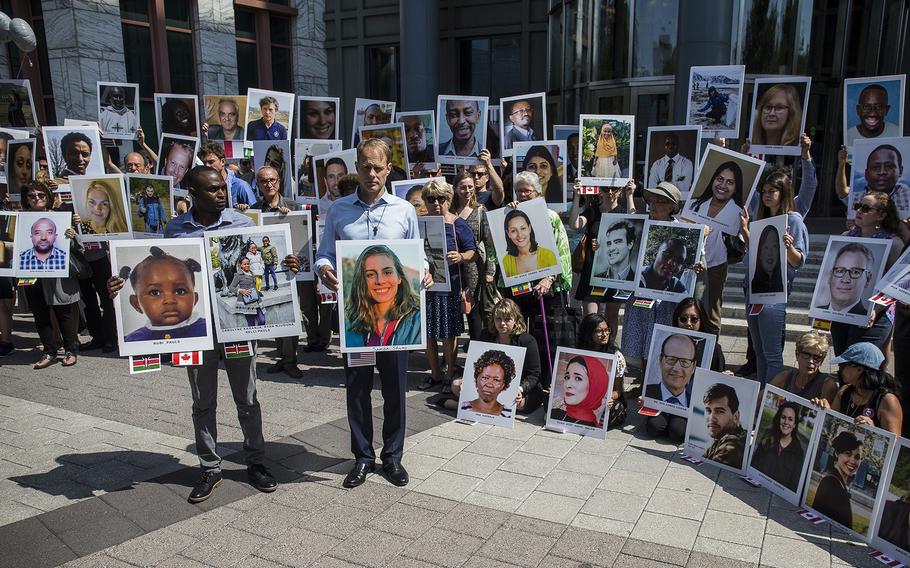 People hold signs in Washington, D.C., on Sept. 10, 2019, during a vigil for victims of the March 10, 2019, Ethiopian Airlines Flight ET302 crash that killed 157 people. 